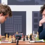 Hans Niemann Signs Autograph for Fan on the Opening Page of a Magnus Carlsen Book