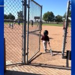 Catch the Action: Young Little Leaguer Takes a Leisurely Stroll